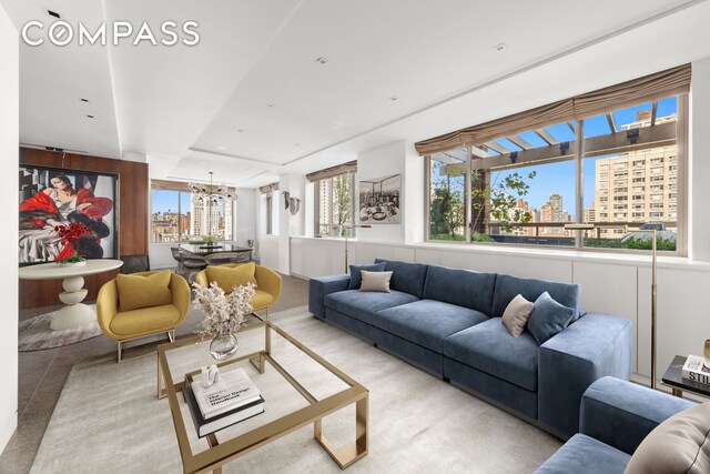 living area featuring a view of city and a chandelier