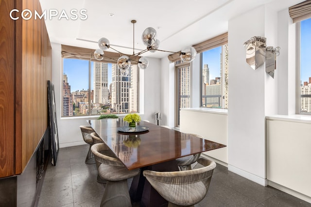 dining room featuring baseboards and a city view