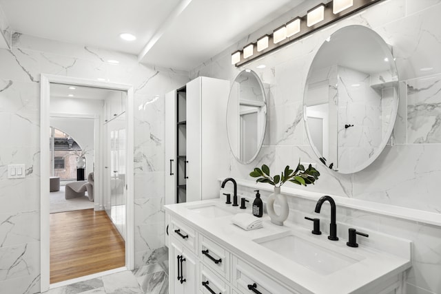 bathroom featuring tile walls and vanity