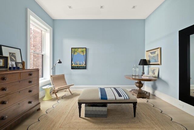 sitting room featuring baseboards and wood finished floors