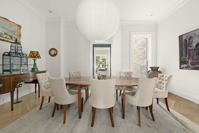 dining space with baseboards and ornamental molding