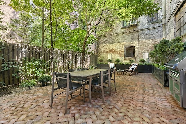 view of patio / terrace with outdoor dining space and fence