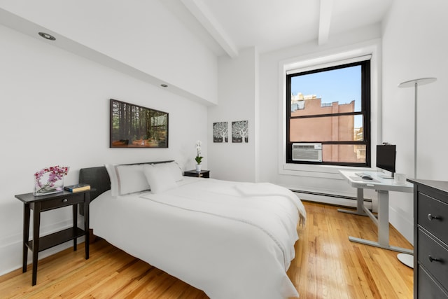 bedroom with a baseboard radiator, cooling unit, beamed ceiling, and wood finished floors