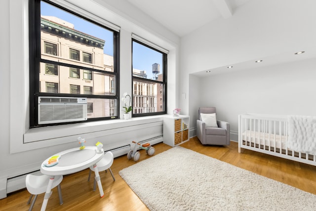 bedroom featuring a crib, beamed ceiling, cooling unit, light wood-type flooring, and recessed lighting