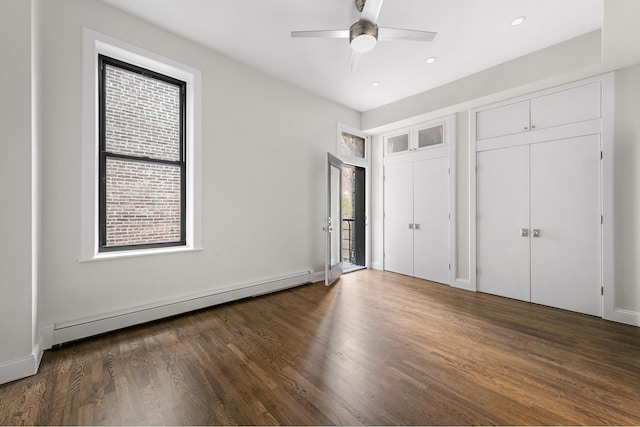 unfurnished bedroom featuring recessed lighting, dark wood-style floors, baseboards, and a baseboard radiator