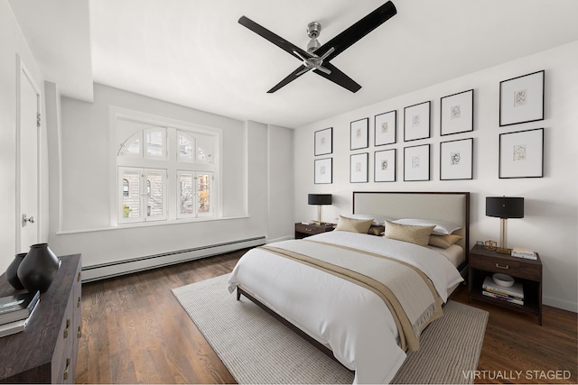 bedroom with wood finished floors, ceiling fan, and a baseboard radiator