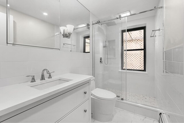 bathroom featuring tiled shower / bath combo, tile walls, tile patterned floors, and vanity