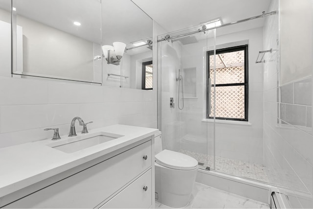 full bath featuring a shower stall, tile walls, toilet, marble finish floor, and baseboard heating