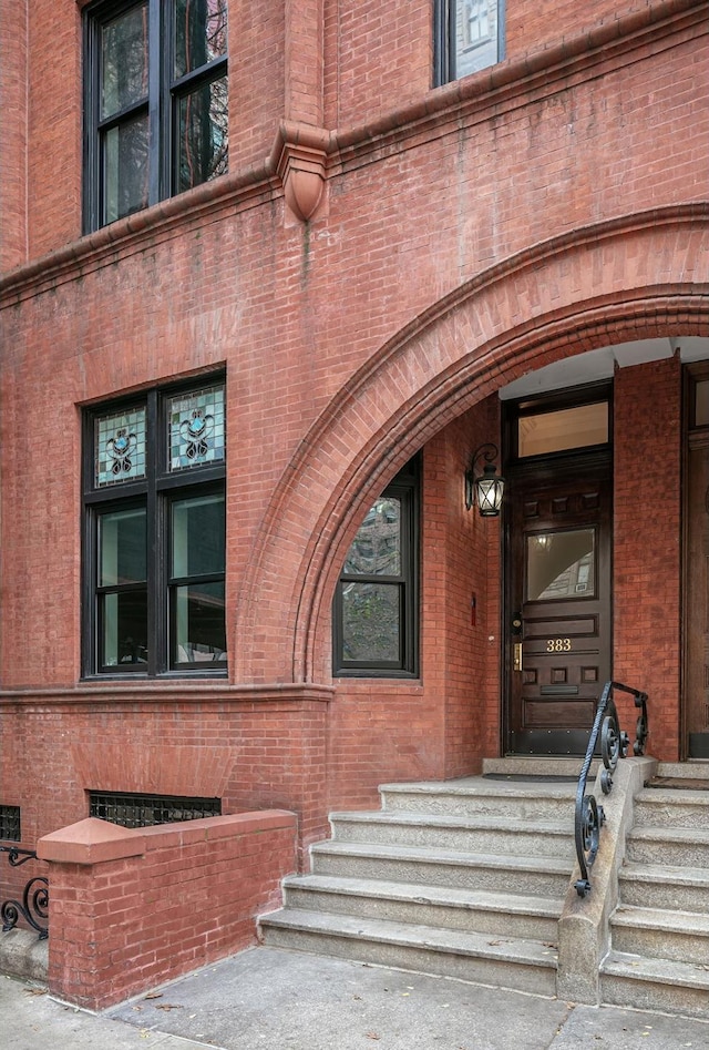 view of exterior entry with brick siding