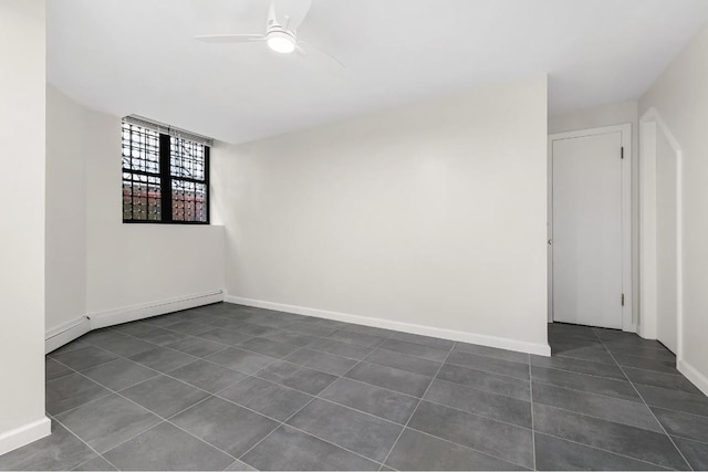 tiled spare room with ceiling fan and a baseboard radiator