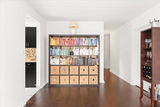 corridor with hardwood / wood-style floors