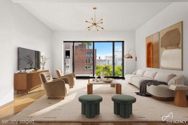 living room featuring light hardwood / wood-style flooring and a notable chandelier