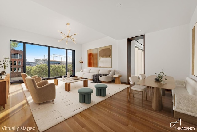 living room with hardwood / wood-style flooring and an inviting chandelier