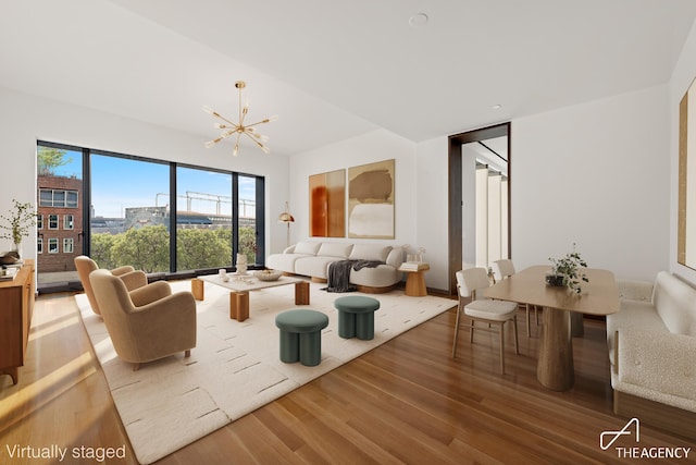 living room with wood finished floors and a notable chandelier