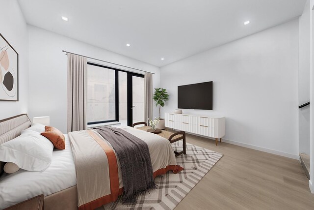 bedroom featuring baseboards, light wood-style flooring, and recessed lighting