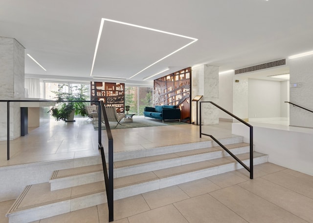 stairway featuring tile patterned flooring