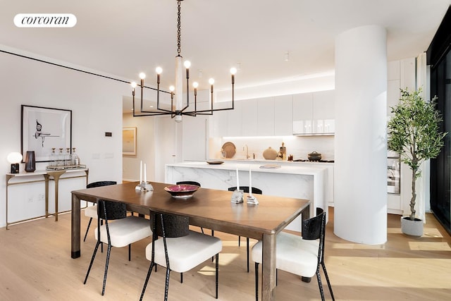 dining area featuring light wood finished floors and visible vents