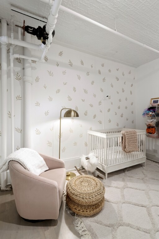 bedroom featuring light hardwood / wood-style floors and a textured ceiling