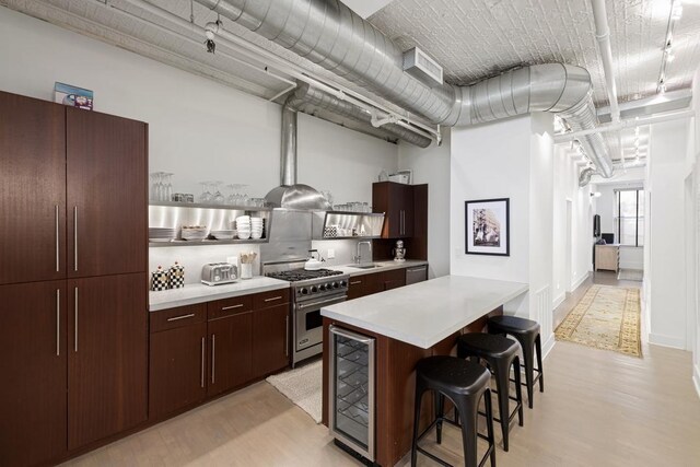 dining room with built in shelves, track lighting, light hardwood / wood-style floors, and a notable chandelier