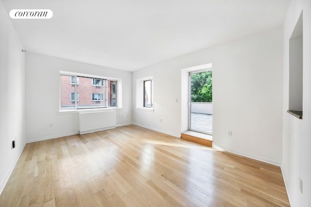 2279 3rd Ave Unit 3C, New York City, NY 10035 - spare room featuring light wood-type flooring, radiator, and baseboards