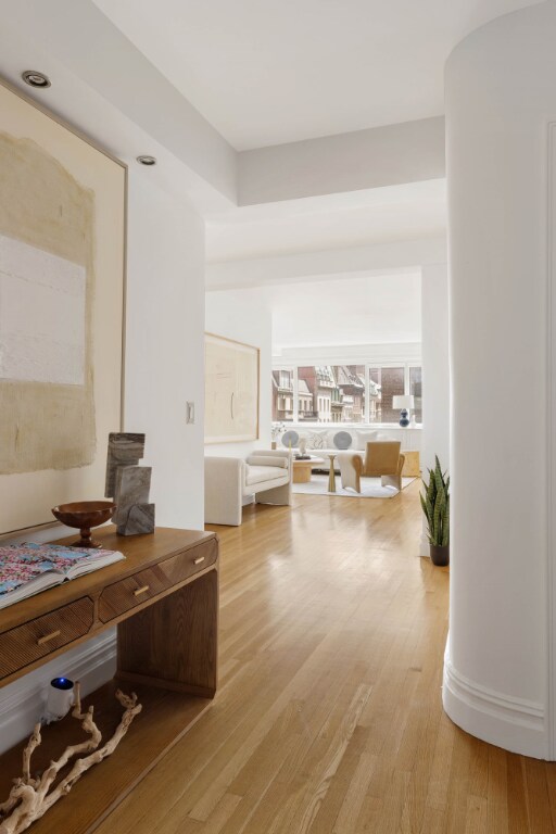 walk in closet with light hardwood / wood-style flooring