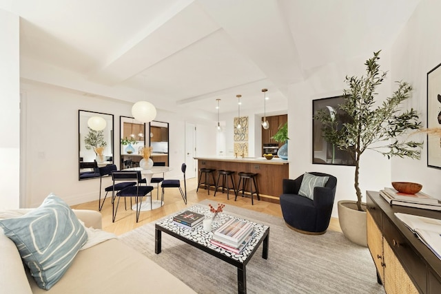 living room with beamed ceiling and light hardwood / wood-style flooring