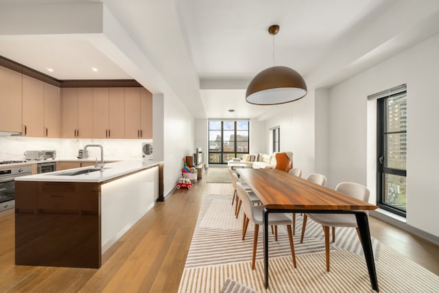 dining space featuring light wood-type flooring and baseboards