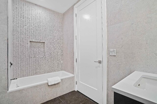 kitchen featuring high end stove, tasteful backsplash, light wood-type flooring, white cabinets, and sink