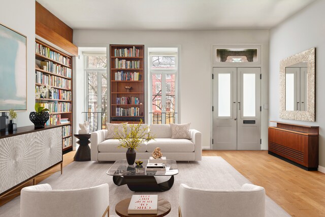 sitting room with french doors and light wood-type flooring