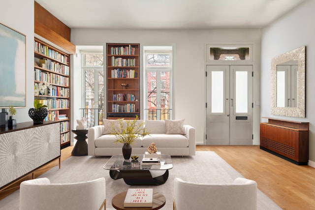 sitting room with french doors and light wood-type flooring