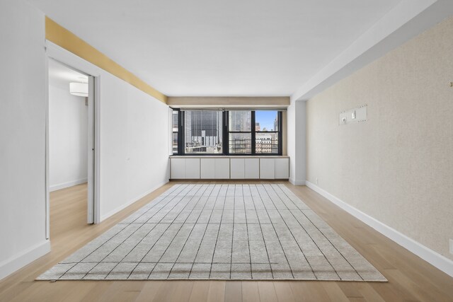 unfurnished room with light wood-type flooring