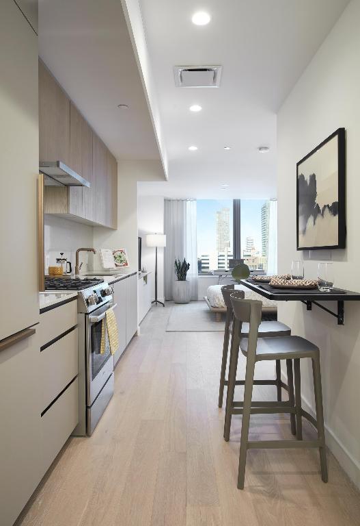 kitchen featuring stainless steel range with gas cooktop, a breakfast bar area, and light wood-type flooring