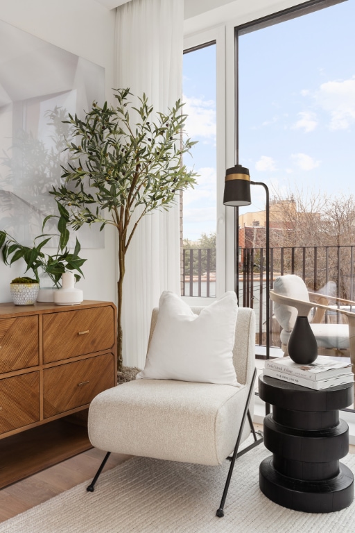 living area with a wealth of natural light and light wood-type flooring