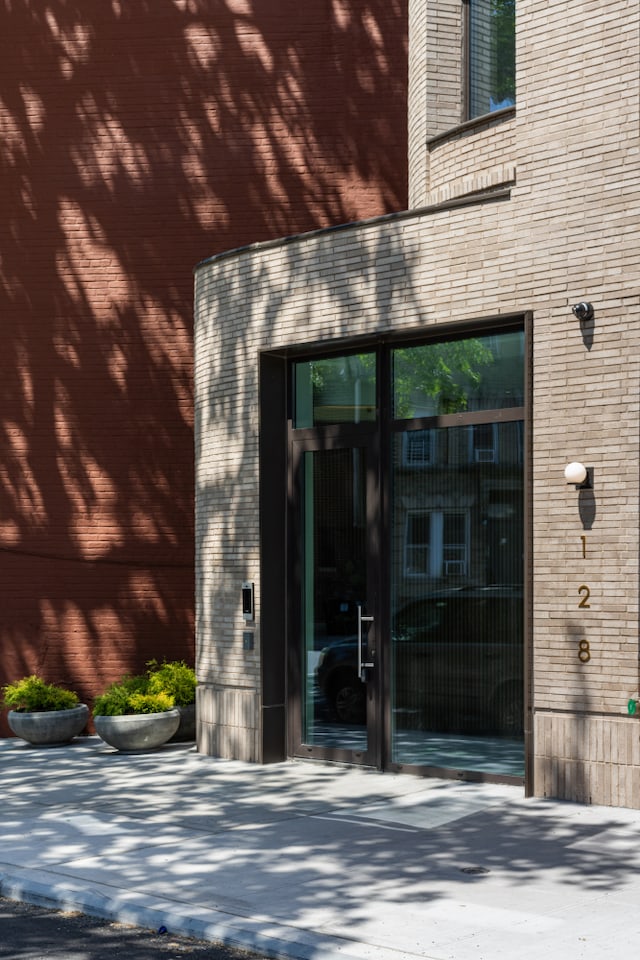 view of exterior entry with brick siding