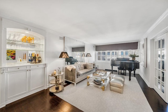 living room featuring indoor bar, dark hardwood / wood-style flooring, and ornamental molding