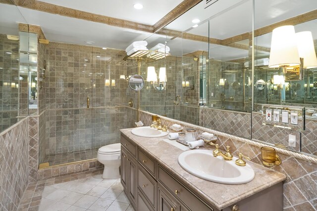 bathroom featuring tile walls, vanity, an enclosed shower, toilet, and tile patterned floors