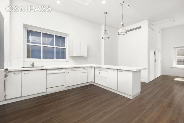 empty room featuring dark wood-type flooring, a skylight, and brick wall