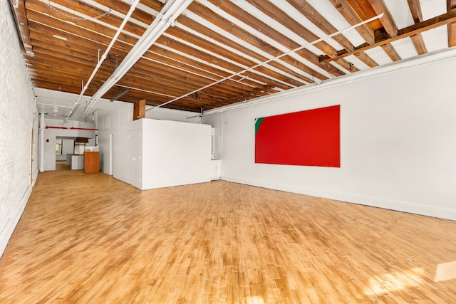 basement with hardwood / wood-style floors