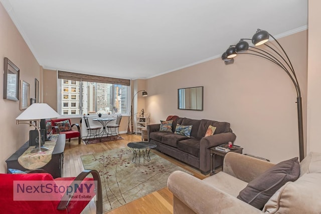 living area with ornamental molding and wood finished floors