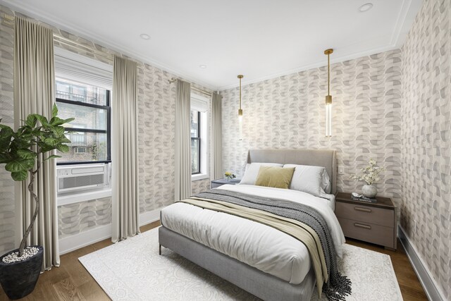 bedroom with ornamental molding, dark hardwood / wood-style floors, and cooling unit