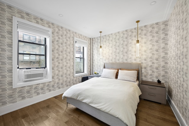 bedroom featuring ornamental molding, dark wood-type flooring, baseboards, and wallpapered walls