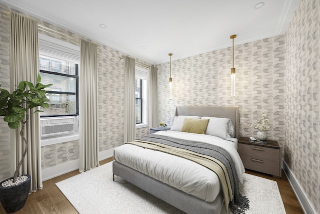 bedroom with baseboards, ornamental molding, dark wood-style flooring, and wallpapered walls