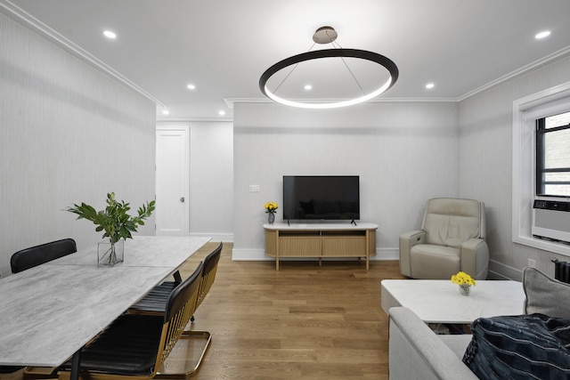 living area with crown molding, recessed lighting, wood finished floors, and baseboards