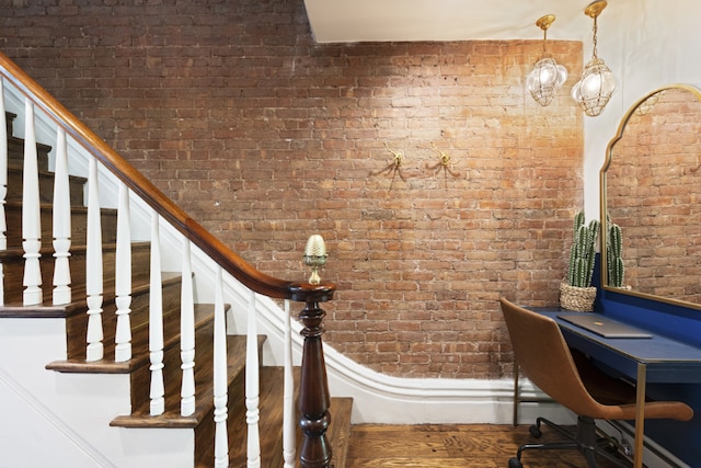 bedroom with brick wall and light wood-type flooring