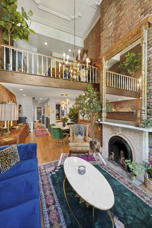 dining room with hardwood / wood-style flooring and brick wall