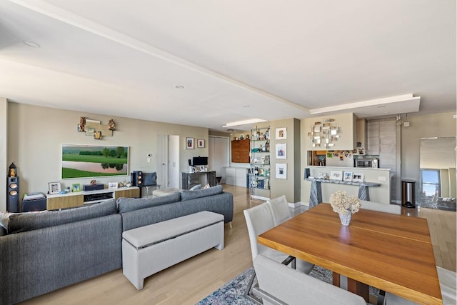 living room with light wood-type flooring and indoor bar