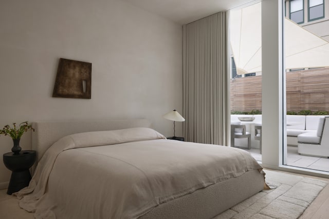 bedroom featuring light hardwood / wood-style flooring and floor to ceiling windows