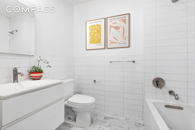 bathroom featuring toilet, shower / tub combination, vanity, marble finish floor, and tile walls