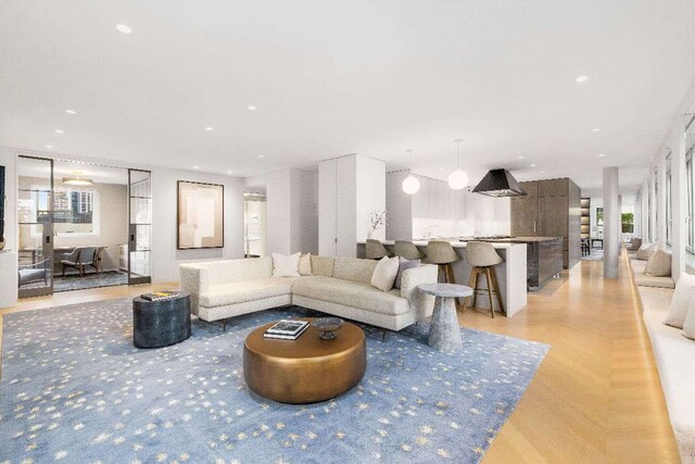 spacious closet with a notable chandelier and light hardwood / wood-style floors