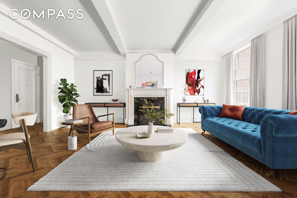 living area featuring beam ceiling, baseboards, and a premium fireplace